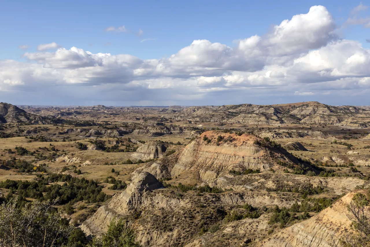 Sweeping panorama of rugged badlands pinnacles and ridges seen from Painted Canyon overlook
