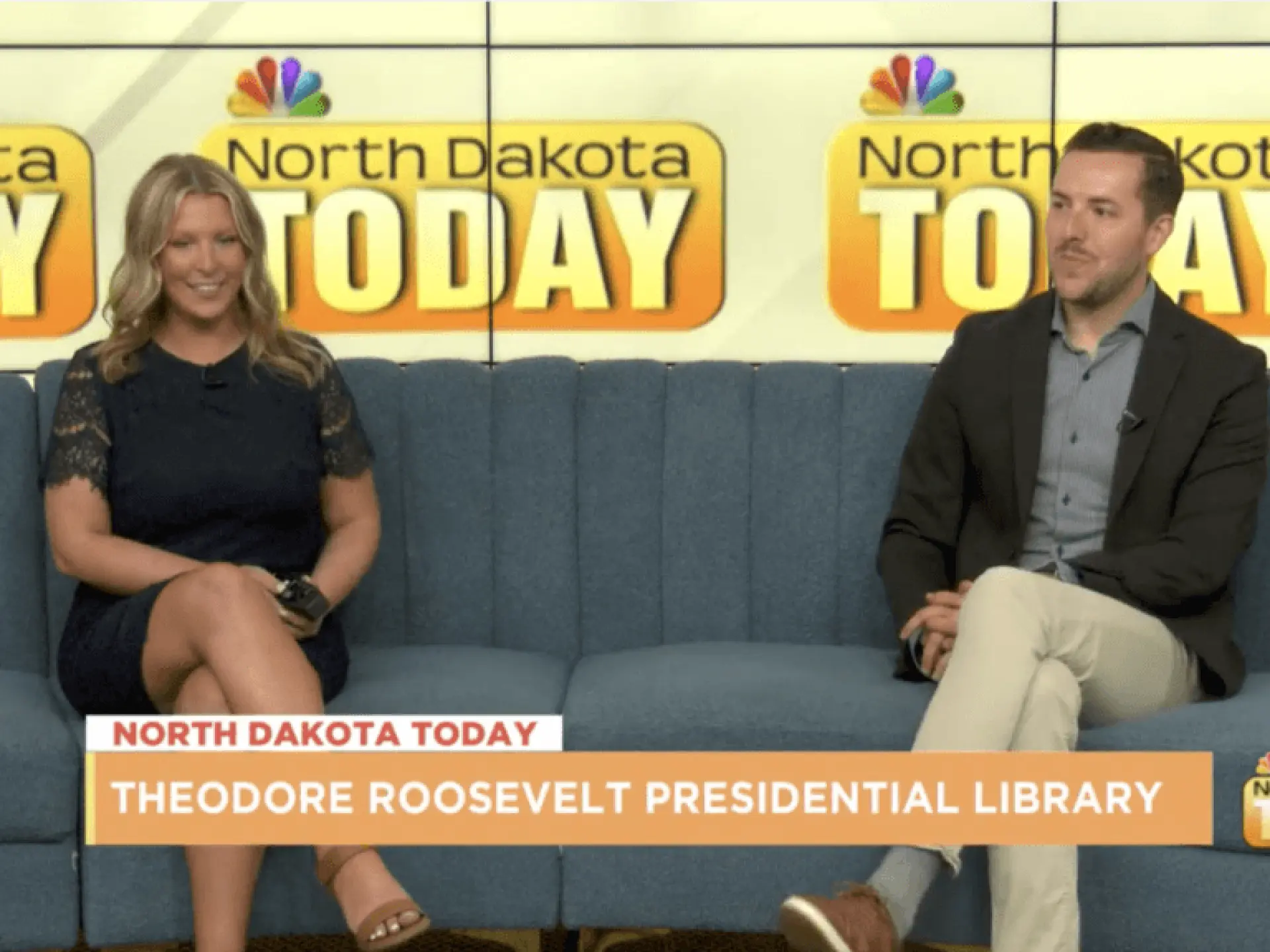 Two people sitting on a sofa during a TV talk show.