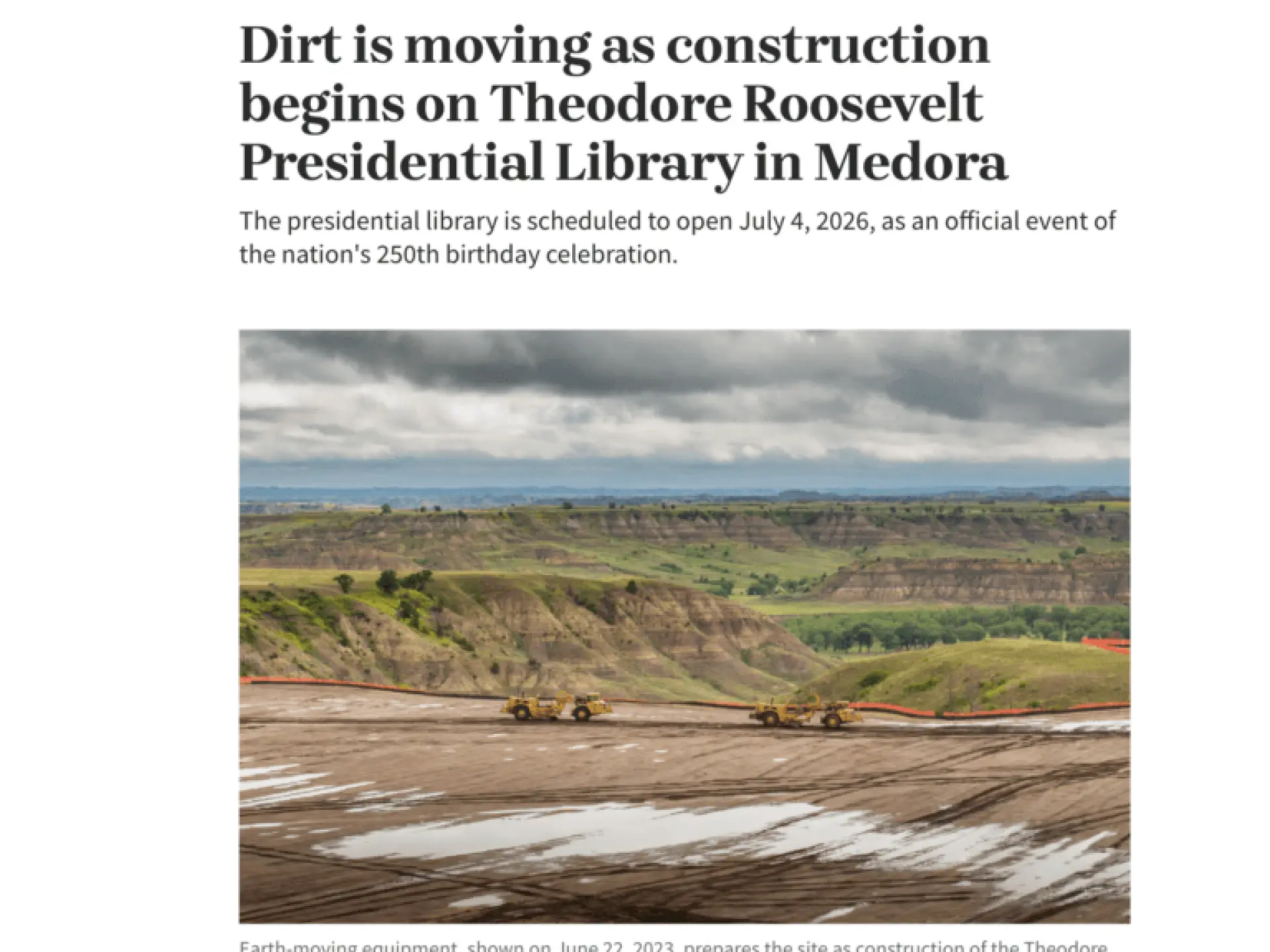 Construction vehicles on muddy landscape under cloudy sky.