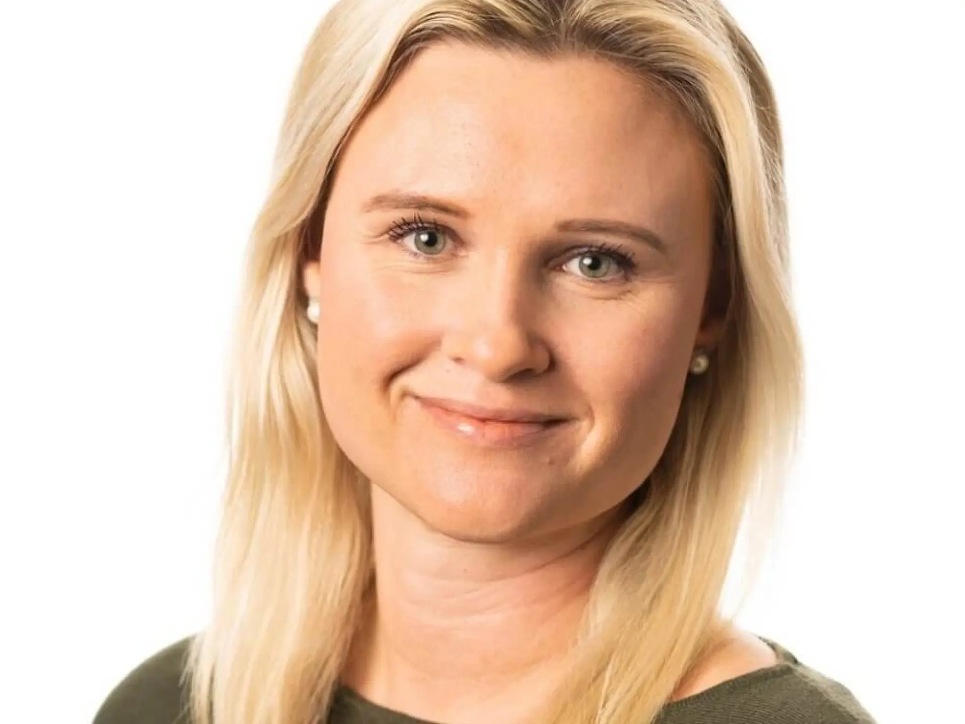 Smiling woman with blonde hair, wearing a green sweater.