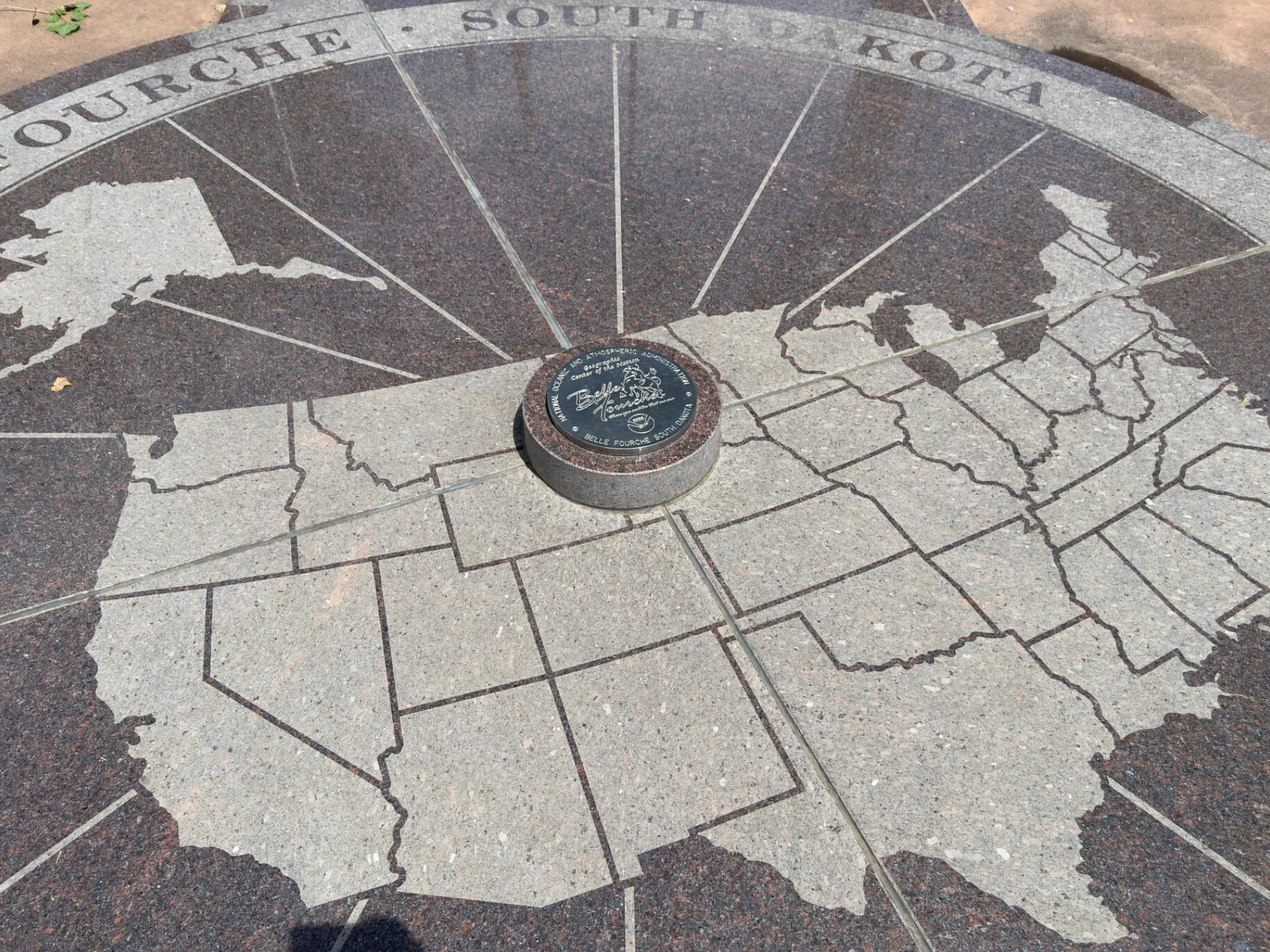 The granite compass rose marking the geographic center of the nation at Belle Fourche, South Dakota, with a map of the United States inlaid in stone