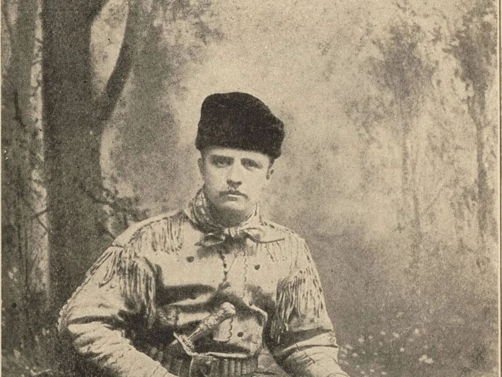 Theodore Roosevelt in fringed buckskin with his rifle