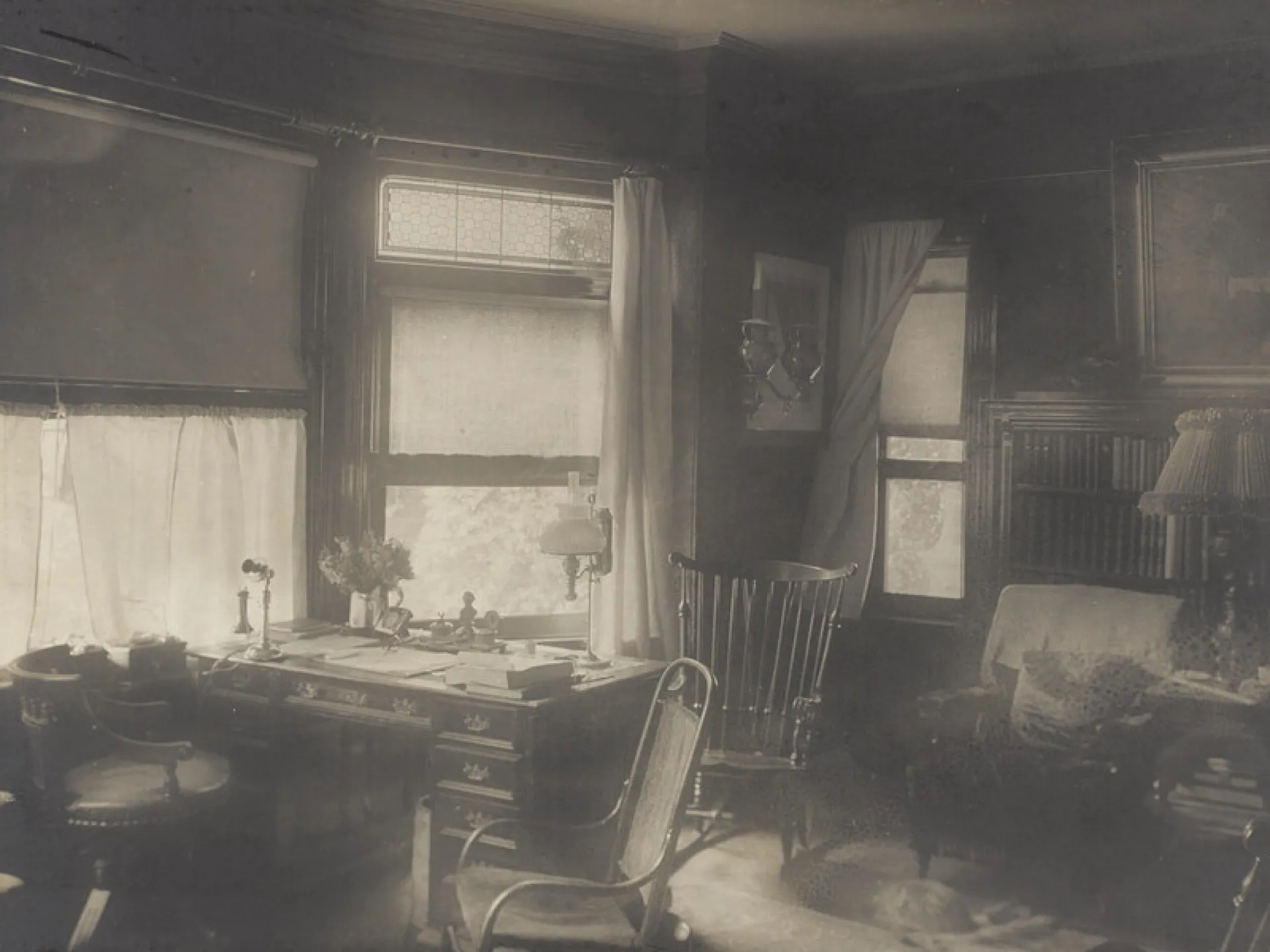 Interior of Theodore Roosevelt's study at Sagamore Hill, with his desk, chairs, and shelves of books
