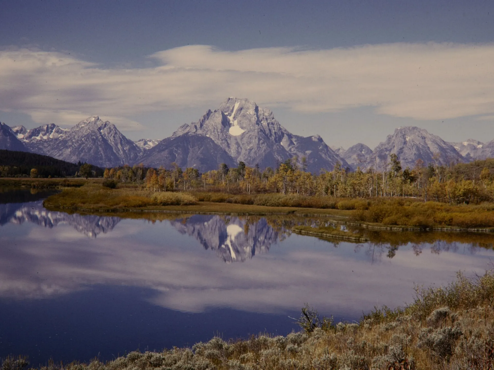 The Teton Range reflected in the Snake River at Oxbow Bend, Grand Teton National Park, in autumn