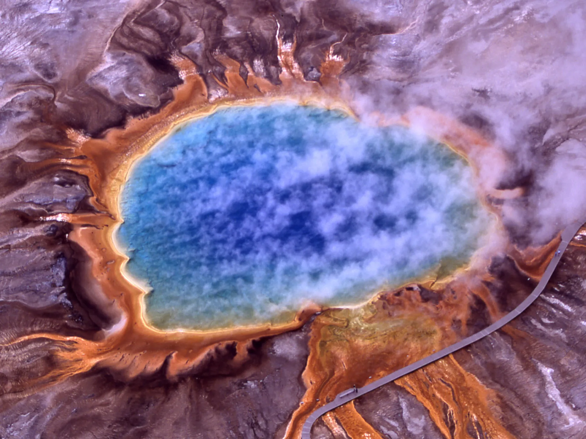 Aerial view of Grand Prismatic Spring in Yellowstone National Park, its blue centre ringed with orange bacterial mats