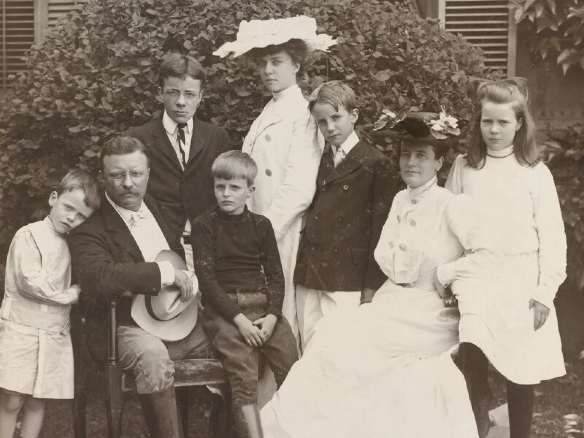 Theodore and Edith Roosevelt with their six children in a garden portrait