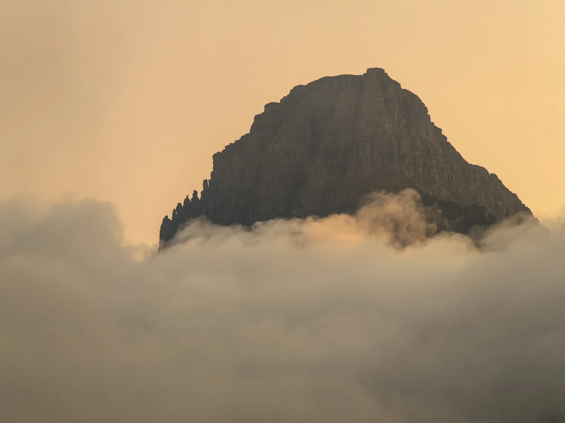 Clements Mountain rising above a layer of cloud at Logan Pass in Glacier National Park, Montana