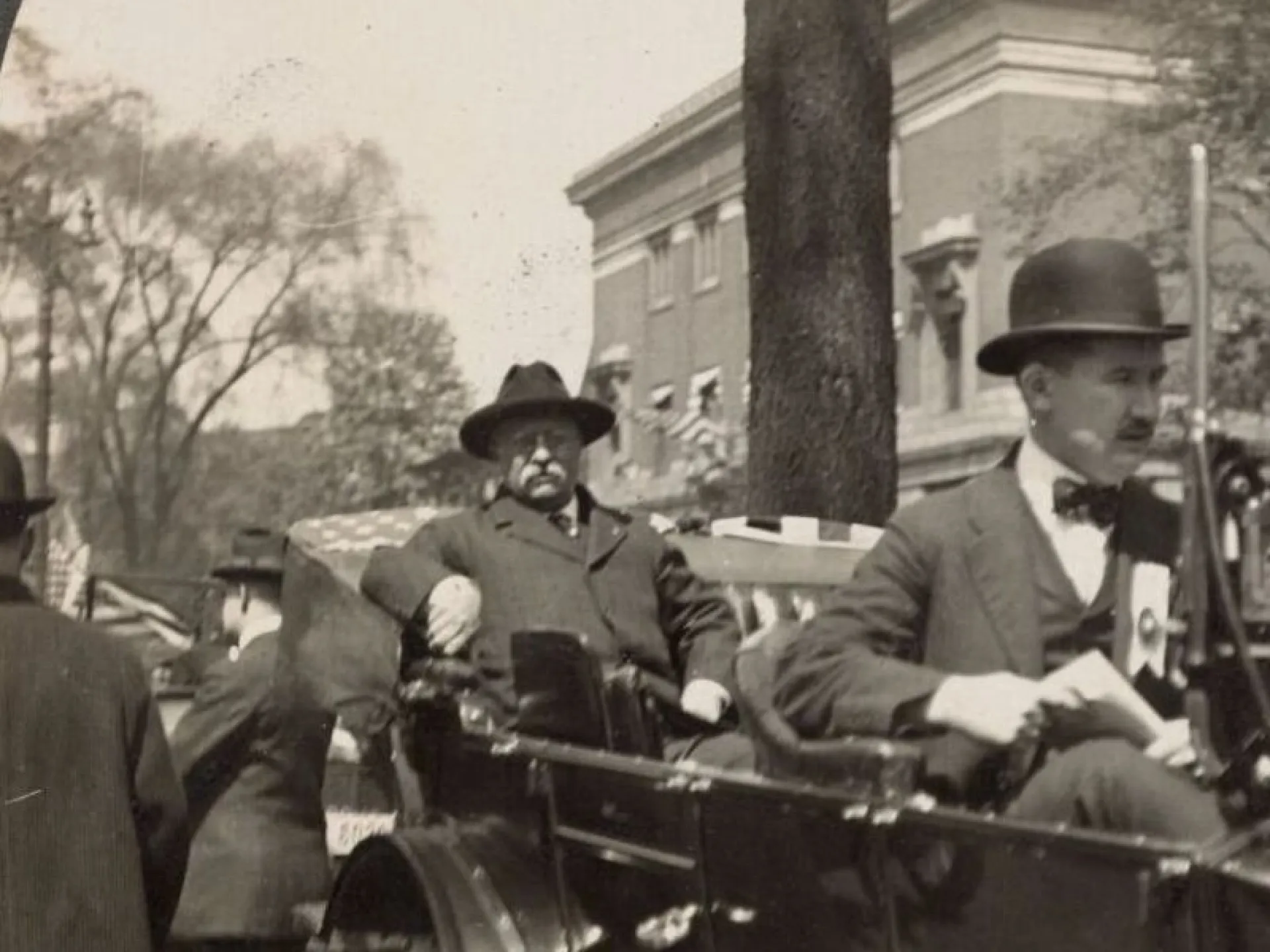 Theodore Roosevelt riding in an open car during the 1912 campaign