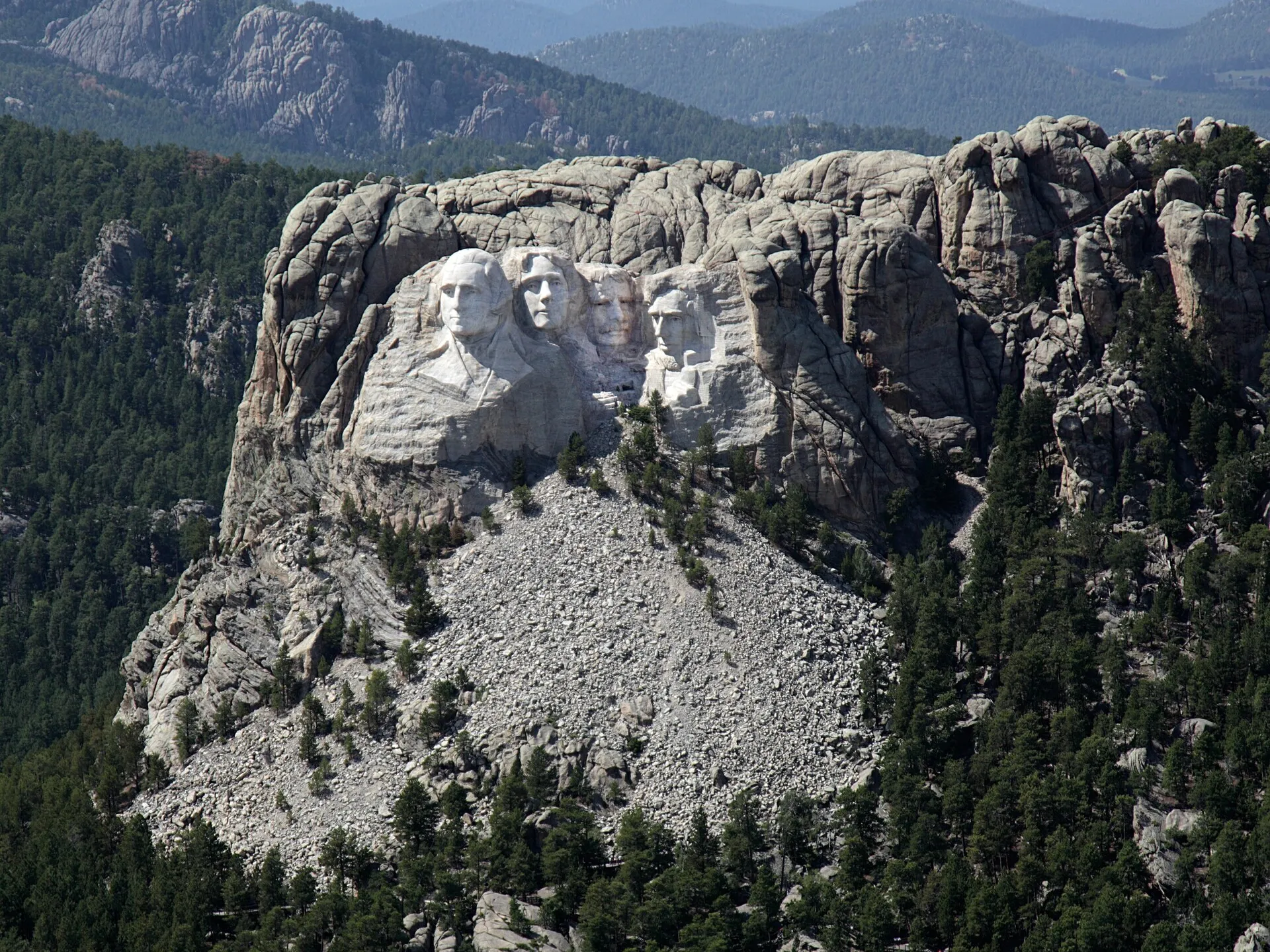 Aerial view of the Mount Rushmore carving in the granite of the Black Hills, surrounded by ponderosa pine