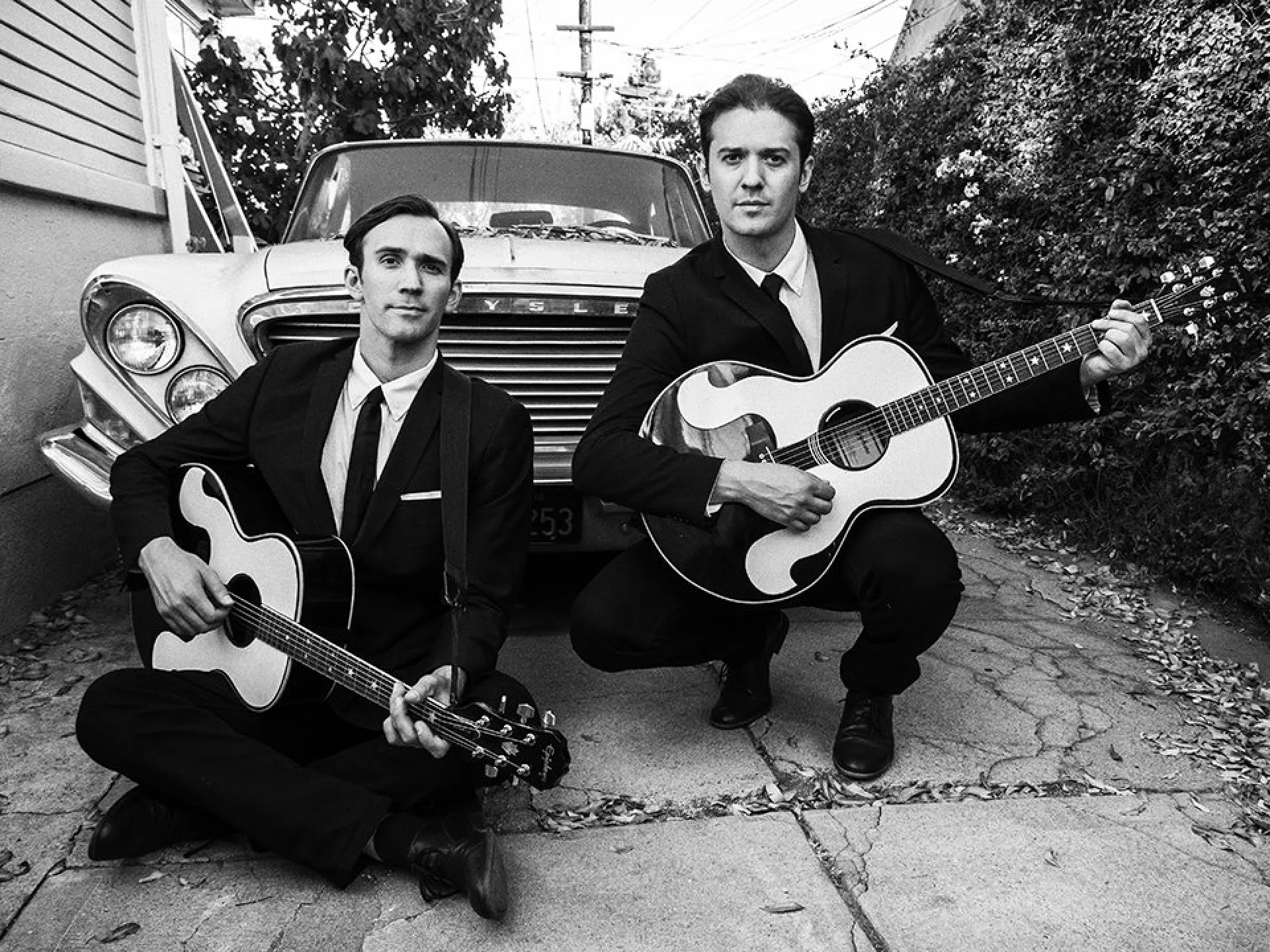 The two performers of The Everly Brothers Experience, holding acoustic guitars.