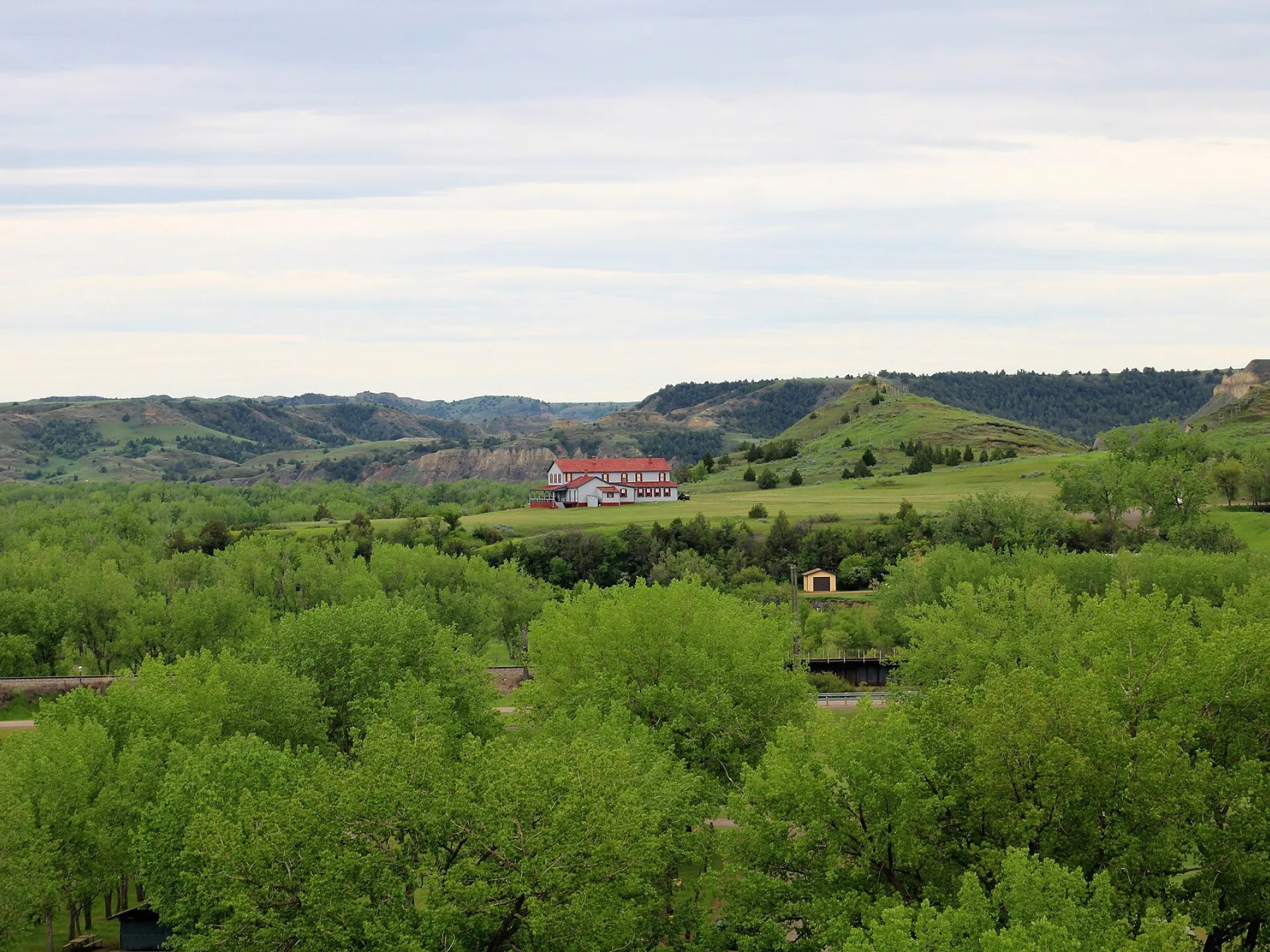 The Chateau de Mores on its bluff above the green Little Missouri River bottomland