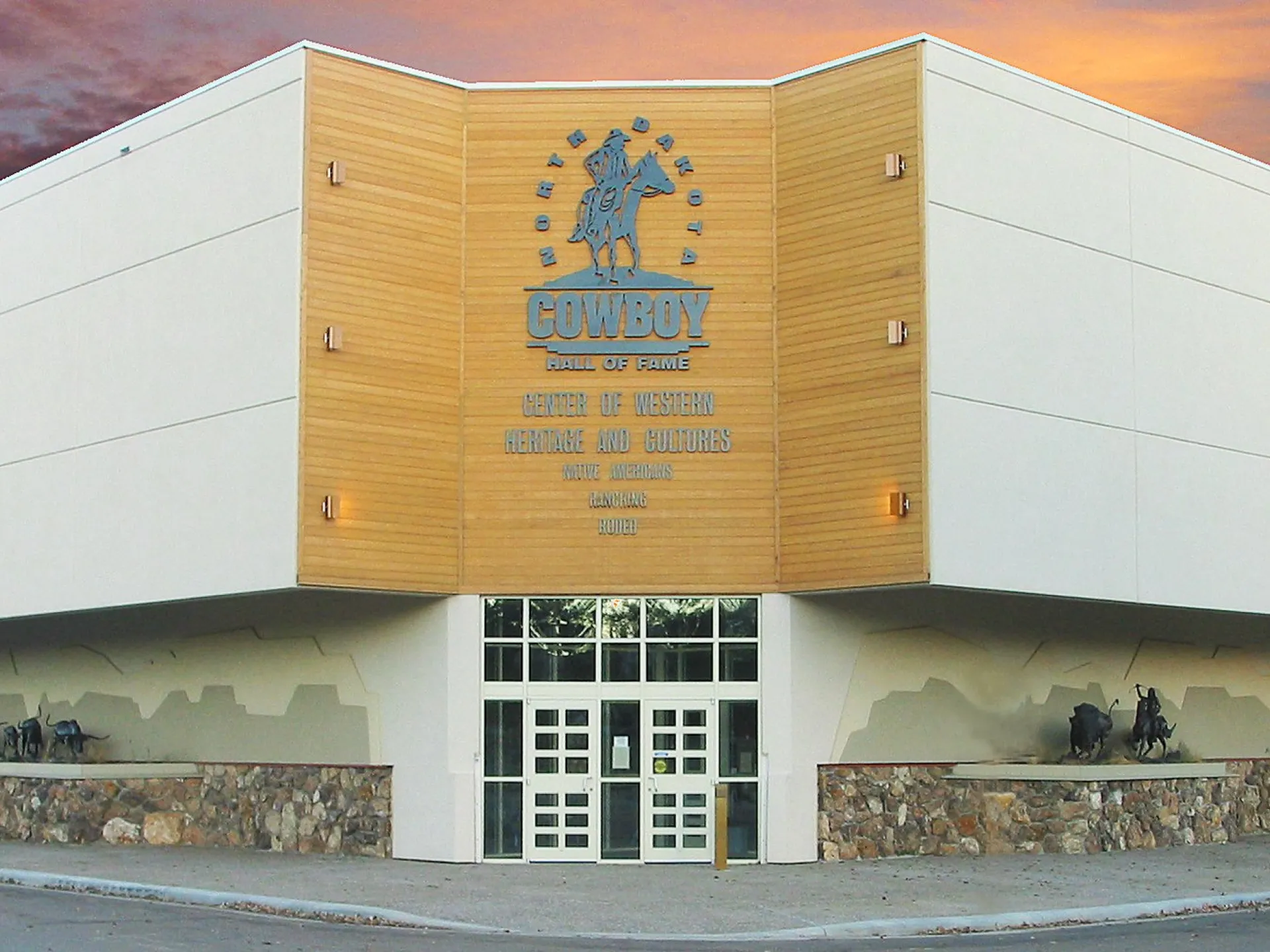 North Dakota Cowboy Hall of Fame building with its gold buckle emblem at sunset