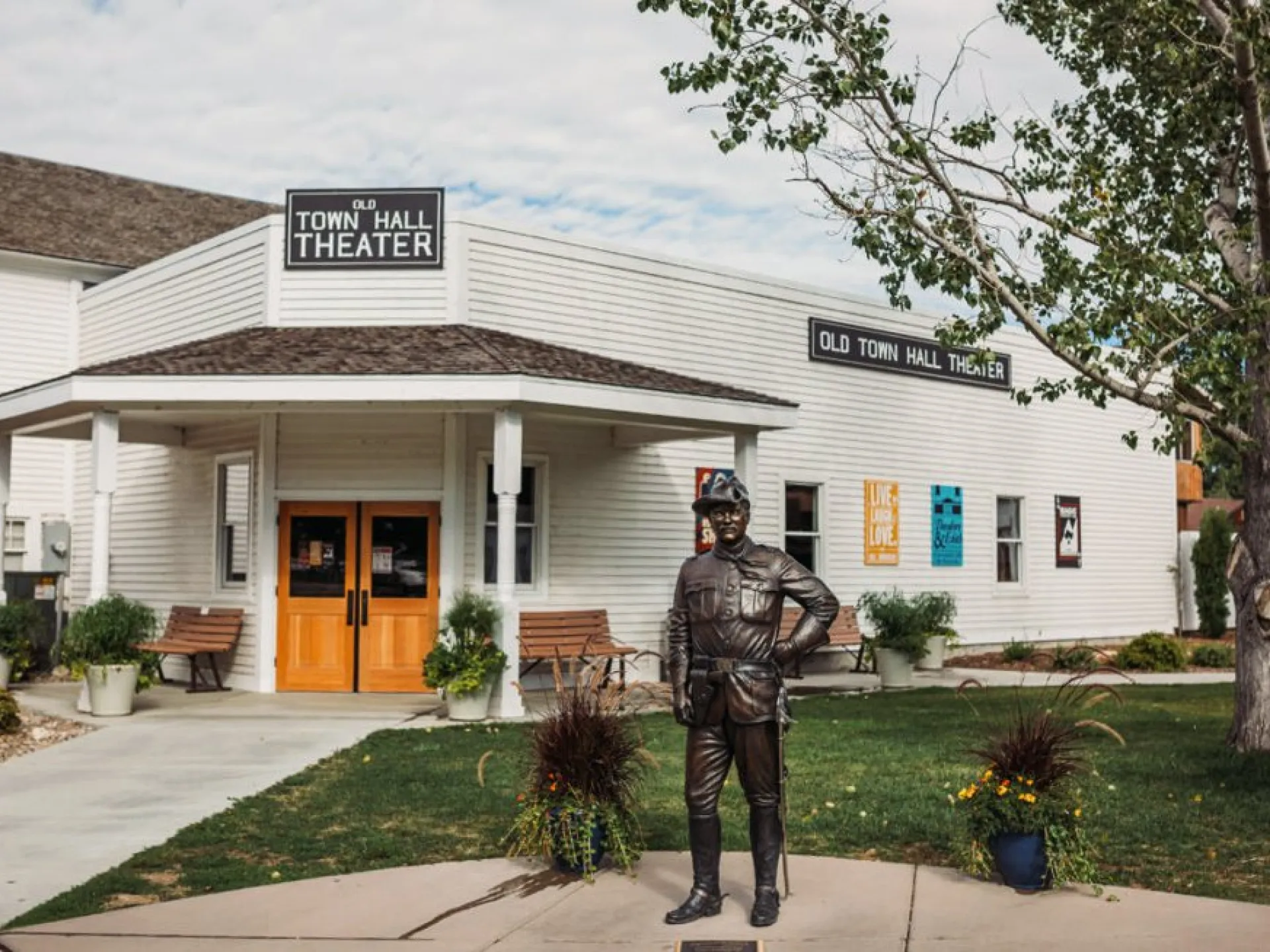 Old Town Hall Theater exterior with a Theodore Roosevelt statue
