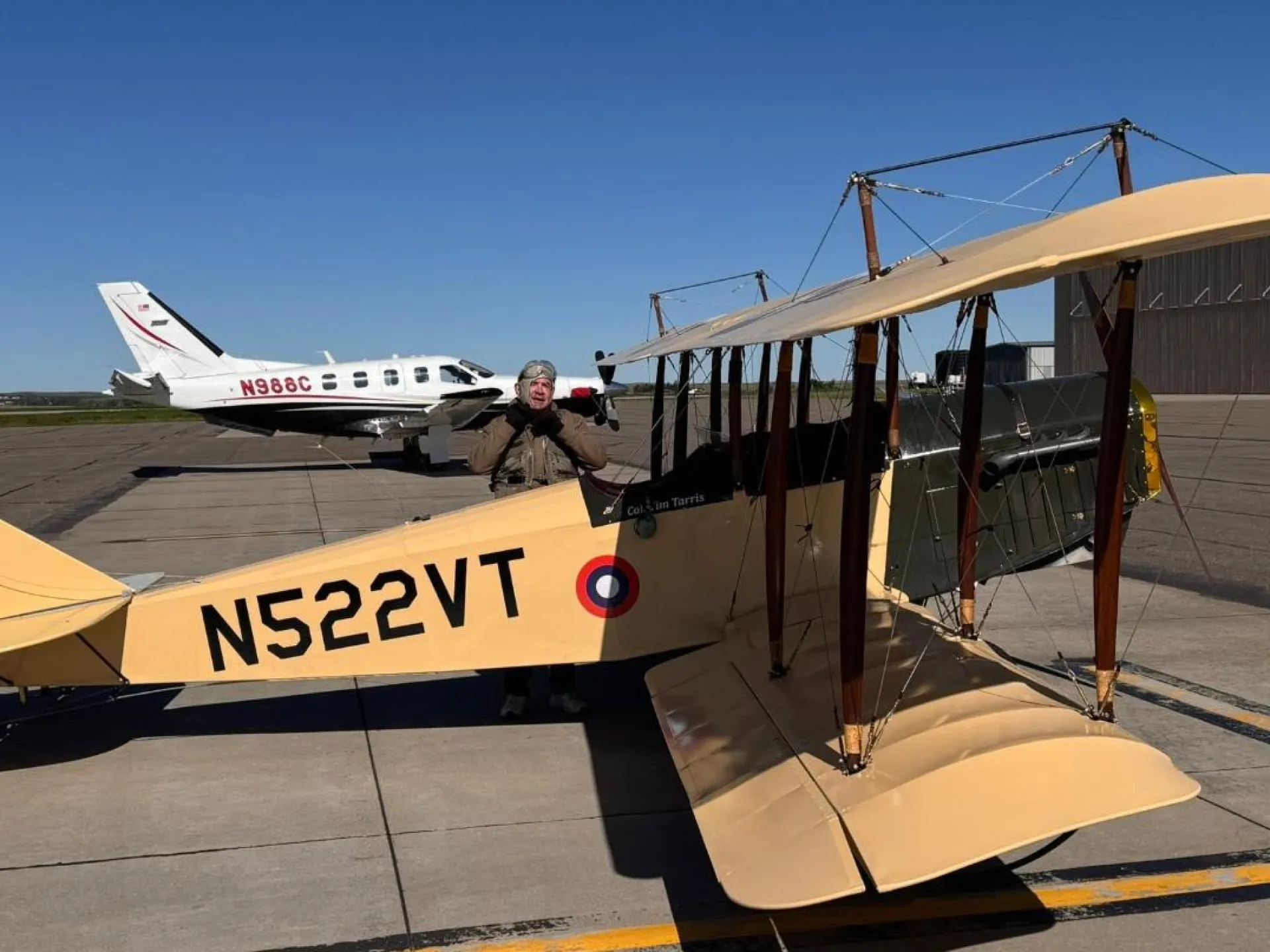A vintage Curtiss Jenny biplane and a TBM turboprop on the ramp at Dickinson Theodore Roosevelt Regional Airport