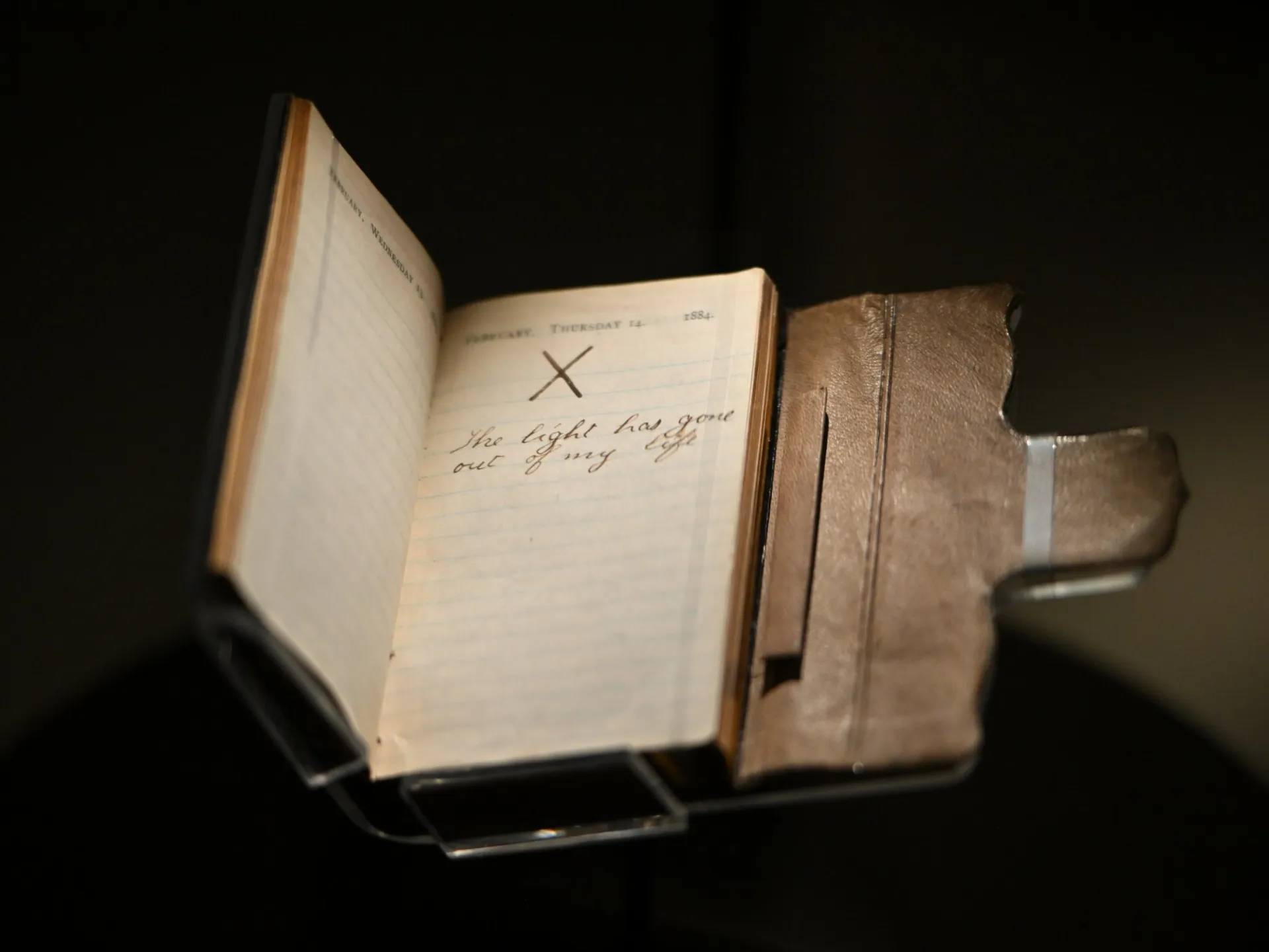 Theodore Roosevelt's 1884 pocket diary on display, open to February 14 with a large X and the words "The light has gone out of my life"