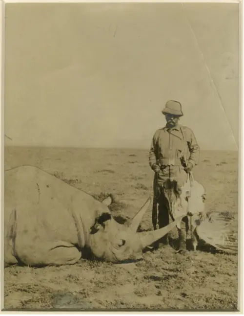 Photograph of Theodore Roosevelt with a rhino he killed