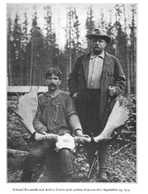 Photograph of Theodore Roosevelt and guide with moose antlers