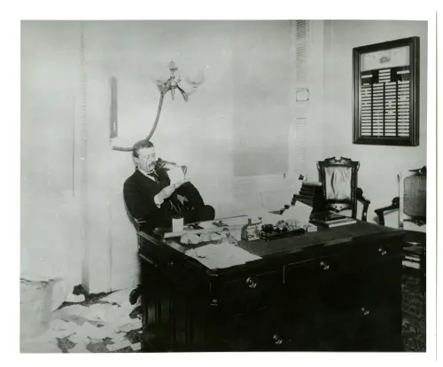 Photograph of Theodore Roosevelt at his desk while police commissioner