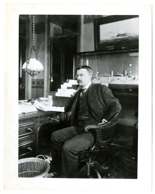 Photograph of Theodore Roosevelt at his desk as assistant secretary of the Navy