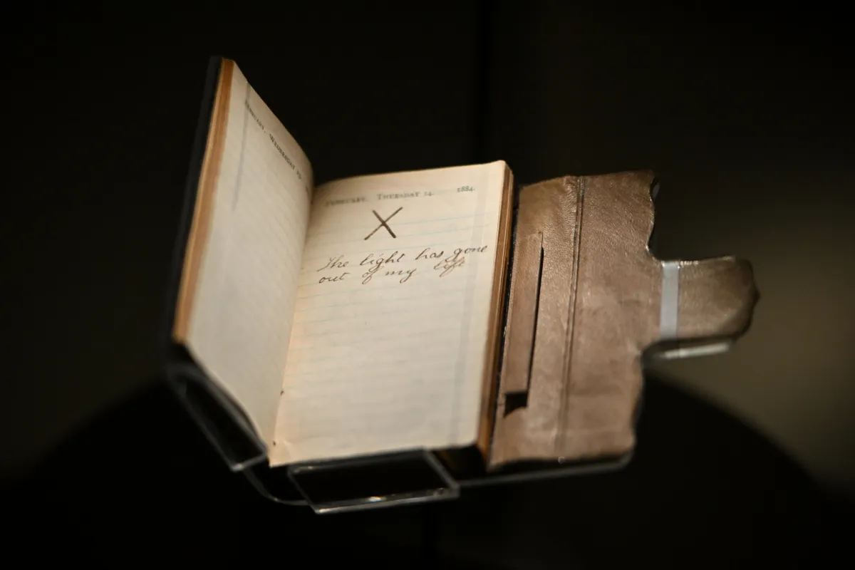 Theodore Roosevelt's 1884 pocket diary on display, open to February 14 with a large X and the words "The light has gone out of my life"