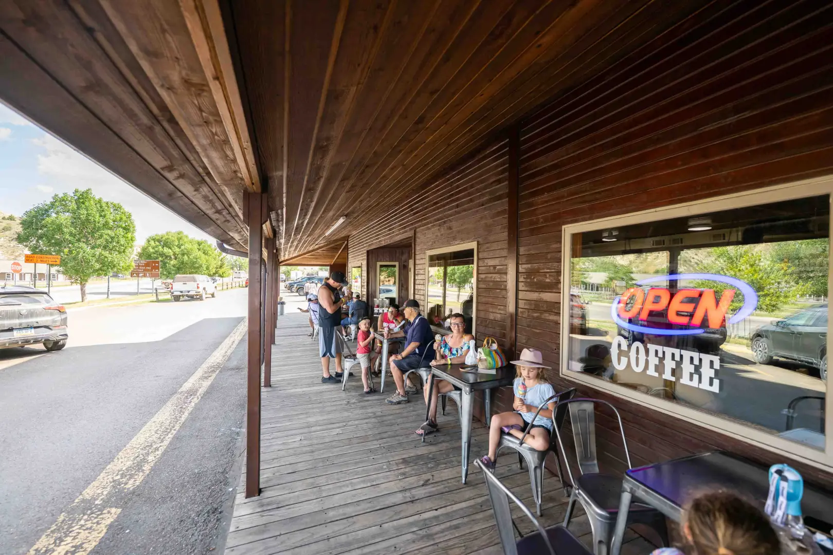 people sitting outside an ice cream and coffee shop