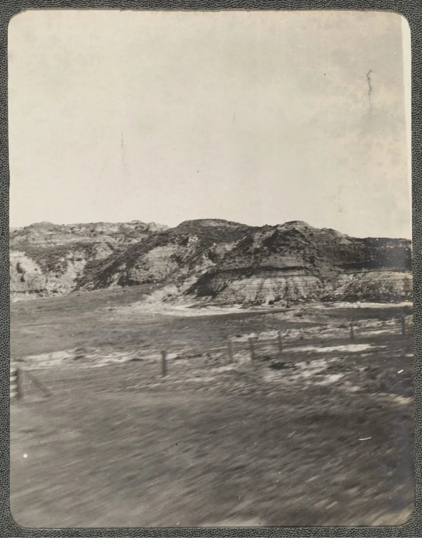 Rugged buttes and rolling badlands beneath an open sky