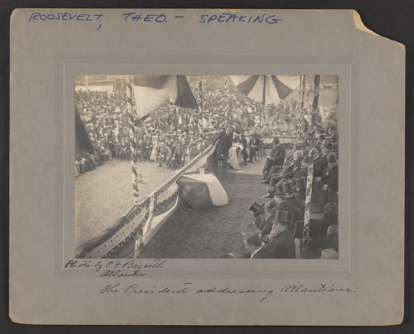 President Theodore Roosevelt addressing a large crowd from a draped platform
