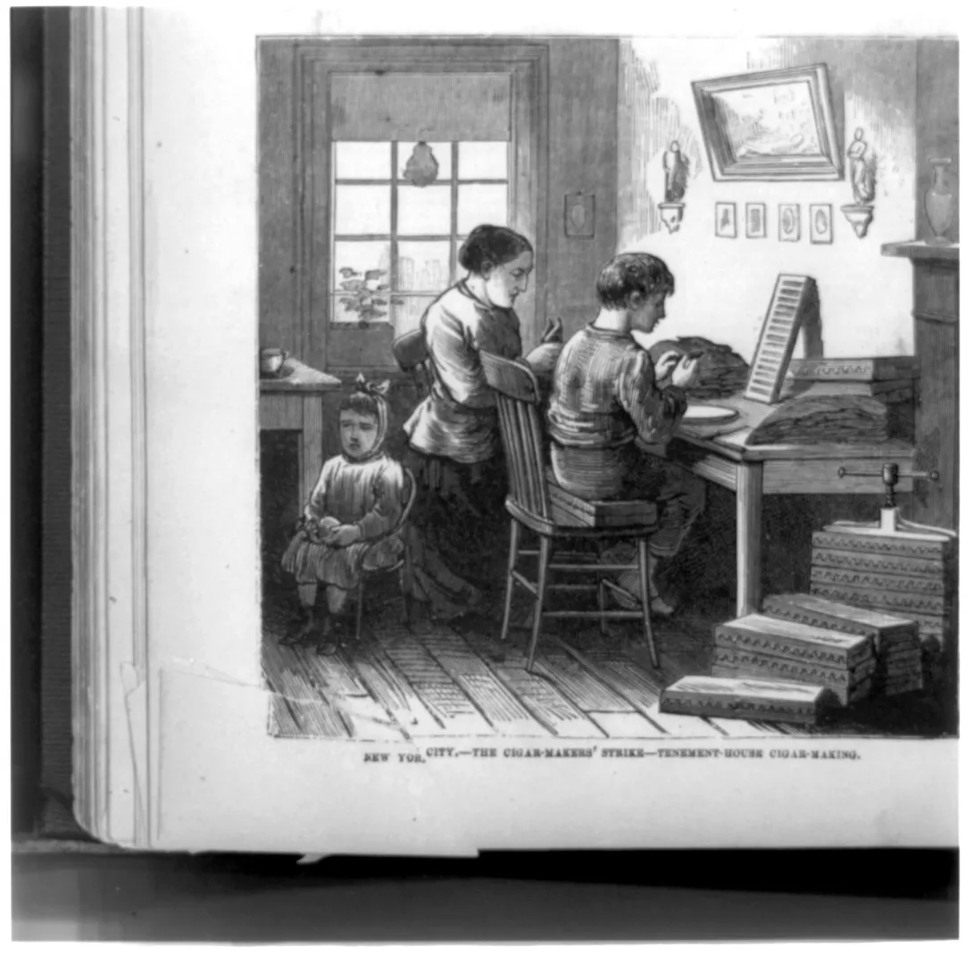 Wood-engraving of a family rolling cigars by hand in a cramped New York tenement room