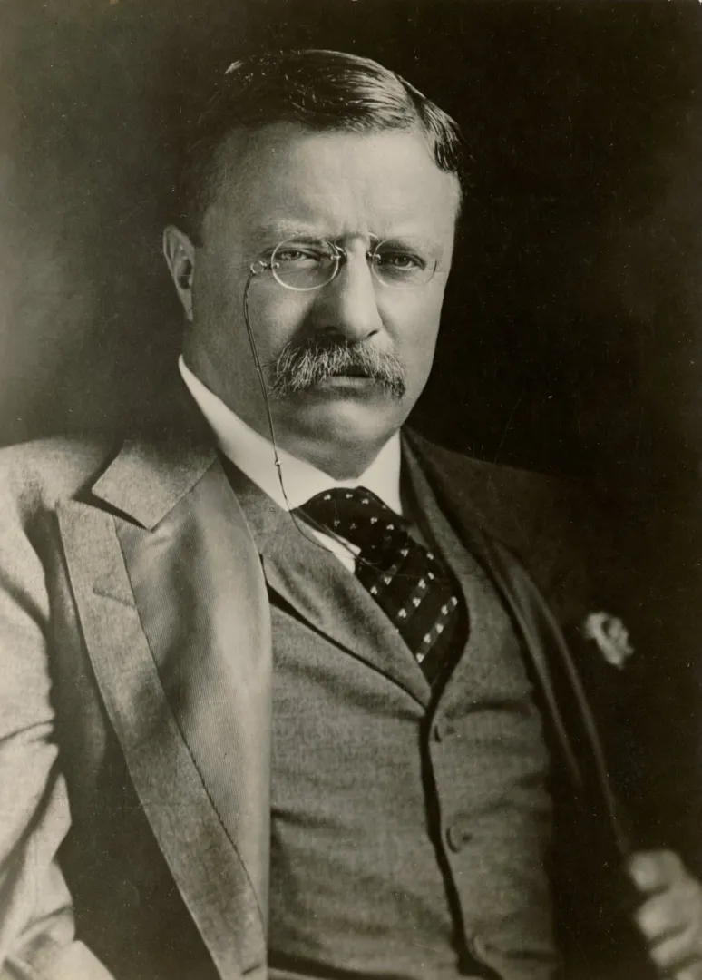 Theodore Roosevelt in a three-piece suit and eyeglasses, portrait taken in August 1901