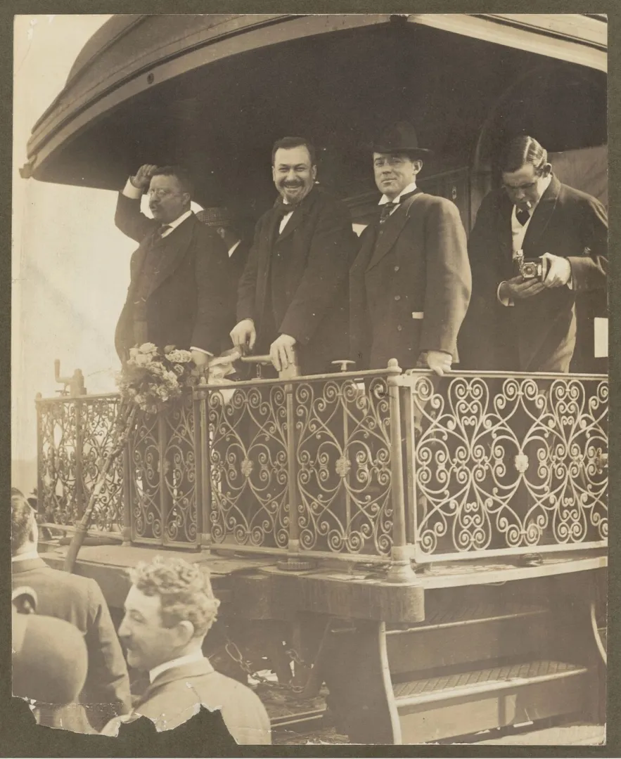 Theodore Roosevelt speaking from the rear platform of a train to a crowd