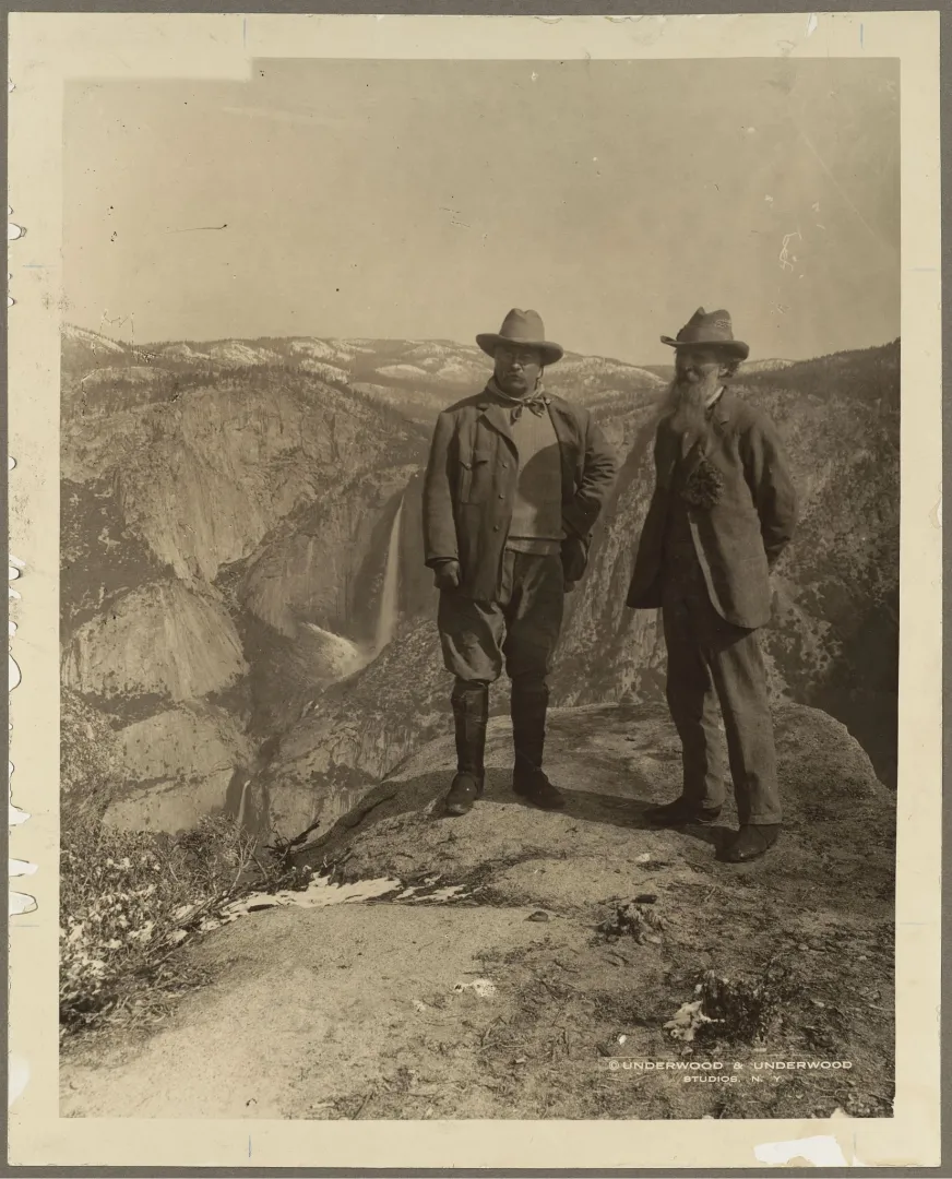 Theodore Roosevelt and John Muir standing on Glacier Point above Yosemite Valley