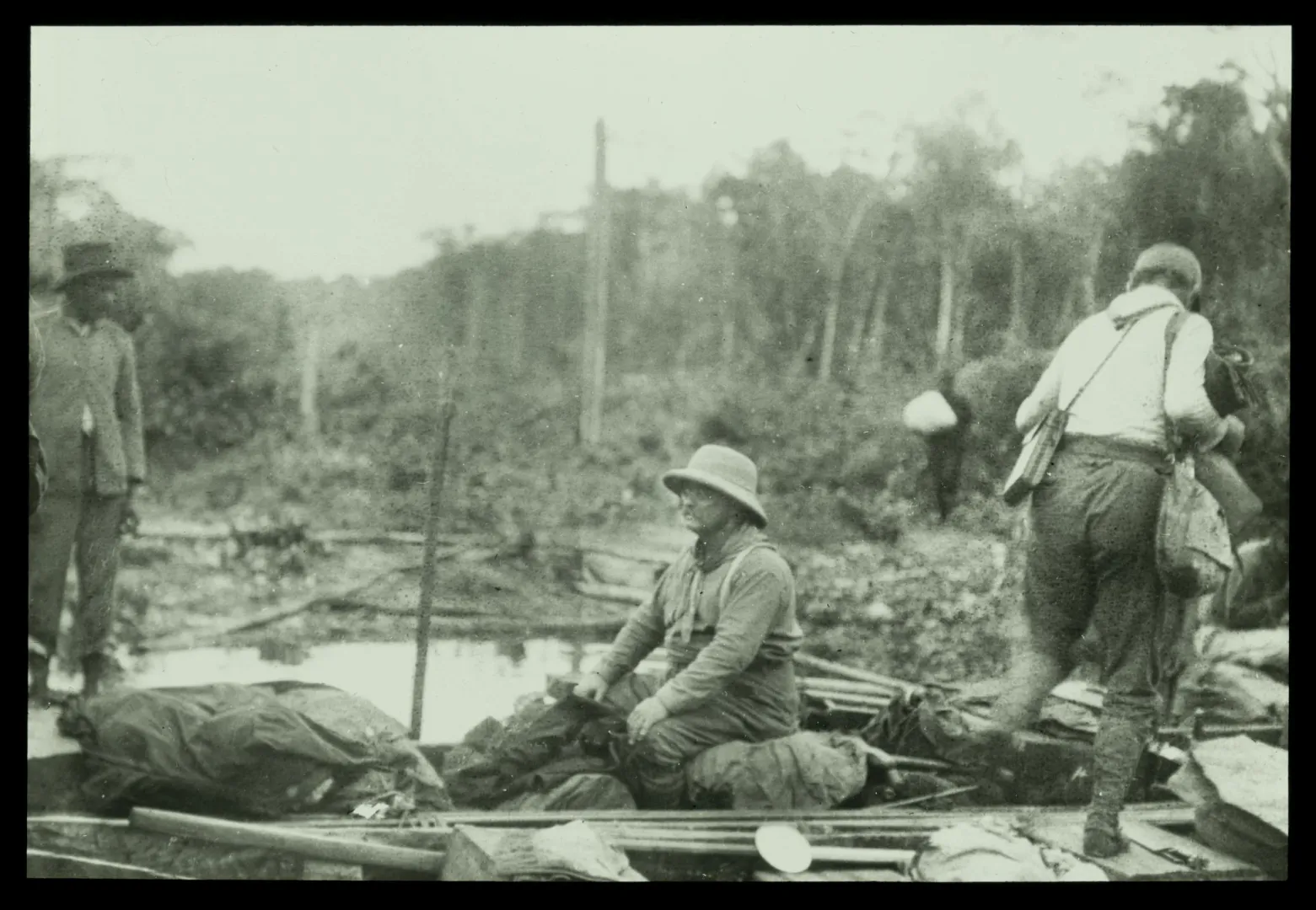 Theodore Roosevelt and companions traveling in dugout canoes on an Amazon river