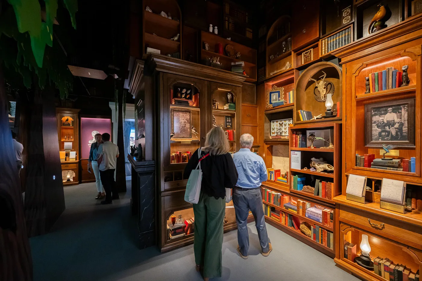 Visitors view artifacts and objects in a richly appointed gallery at the Theodore Roosevelt Presidential Library