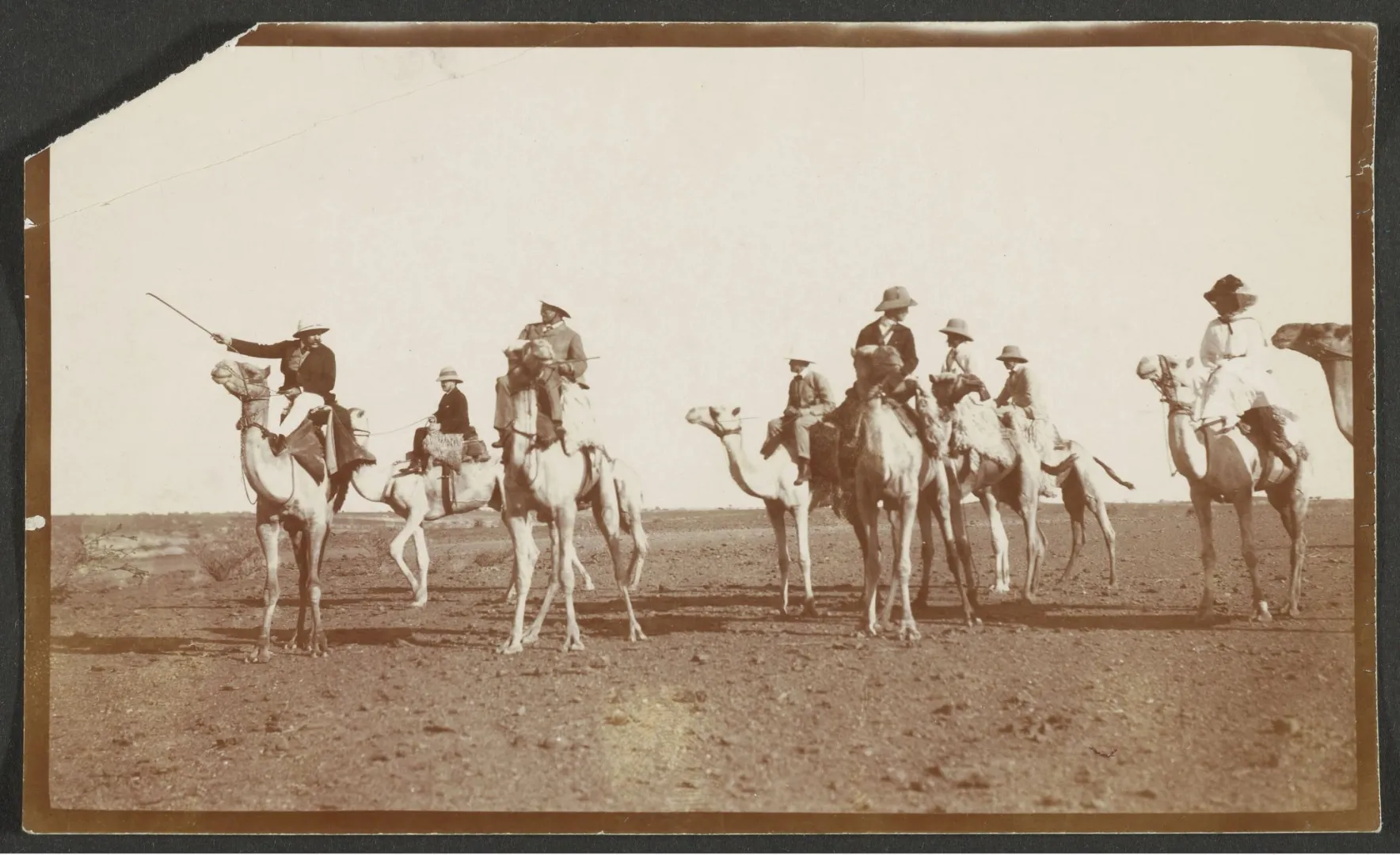 Mounted party riding camels across the desert near Khartoum