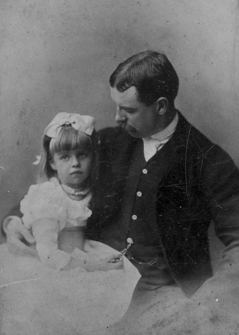 Elliott Roosevelt seated with his young daughter Eleanor on his lap