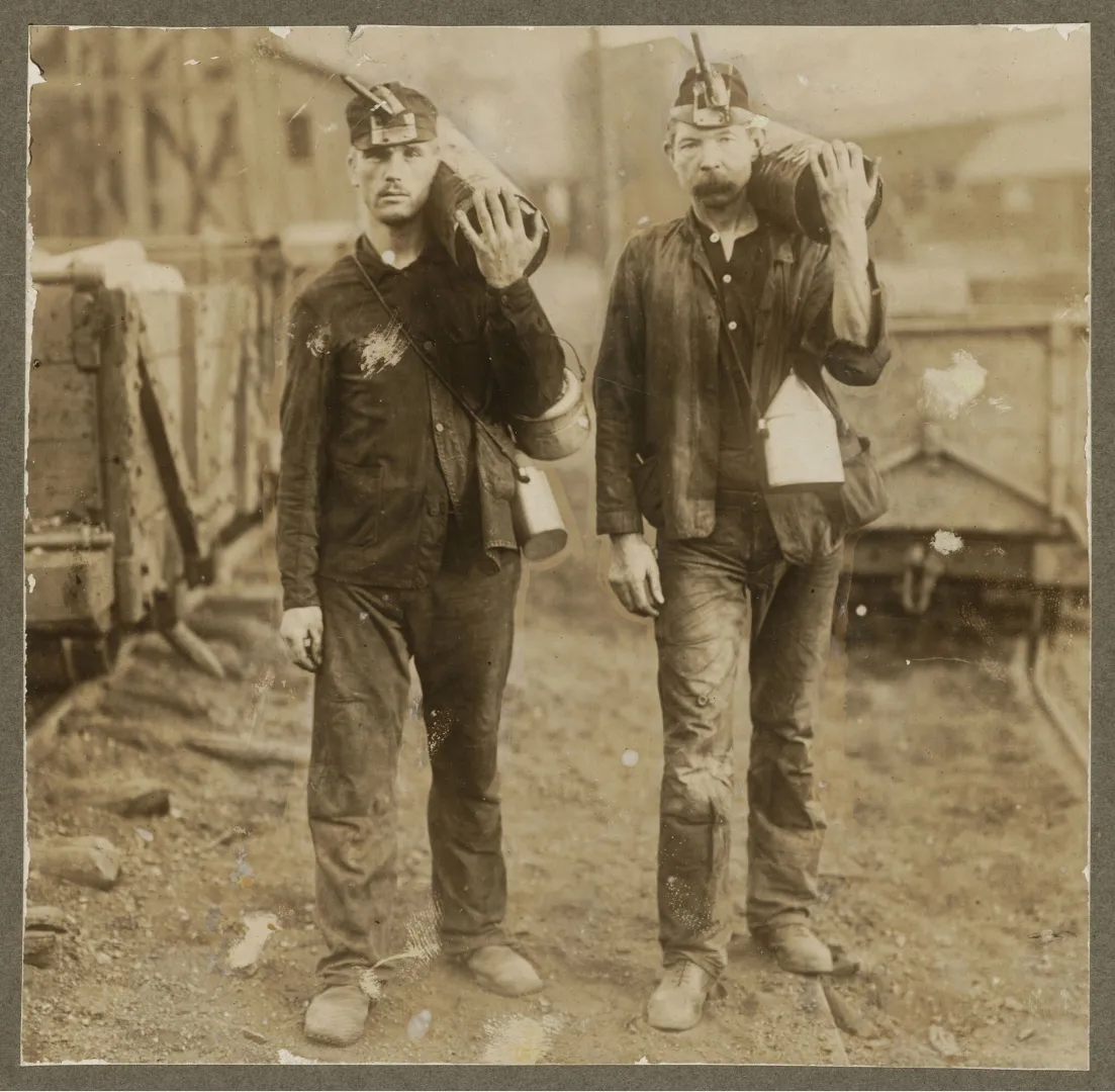 Two coal miners posed at a mine in the early 1900s