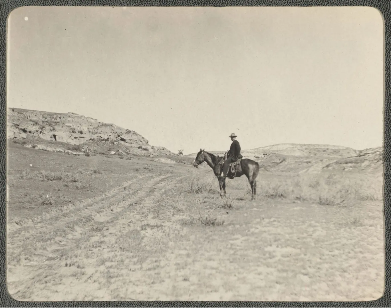 Theodore Roosevelt on horseback amid the buttes of the Dakota Badlands near Medora.