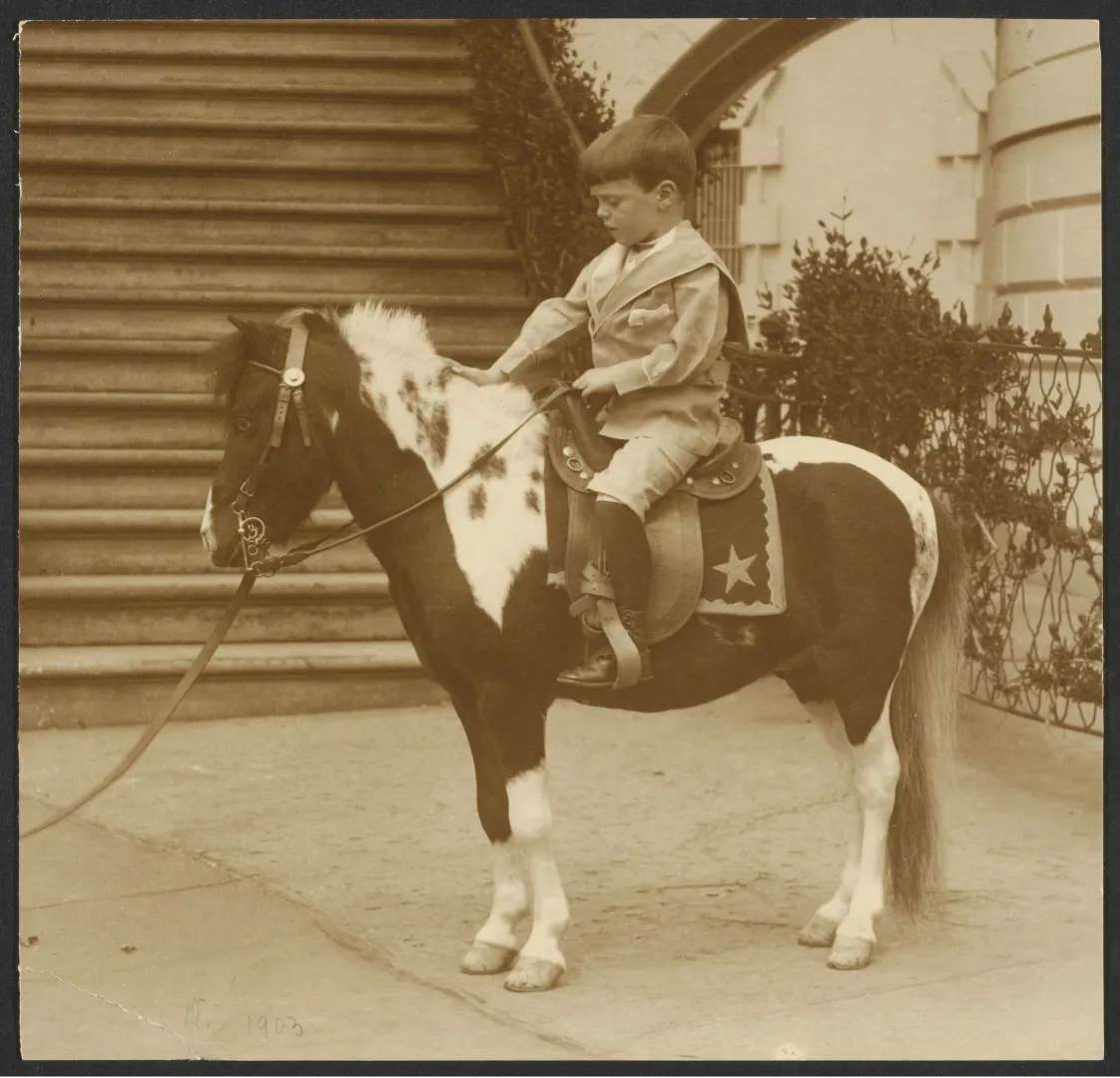 Young Quentin Roosevelt riding the calico pony Algonquin outside the White House