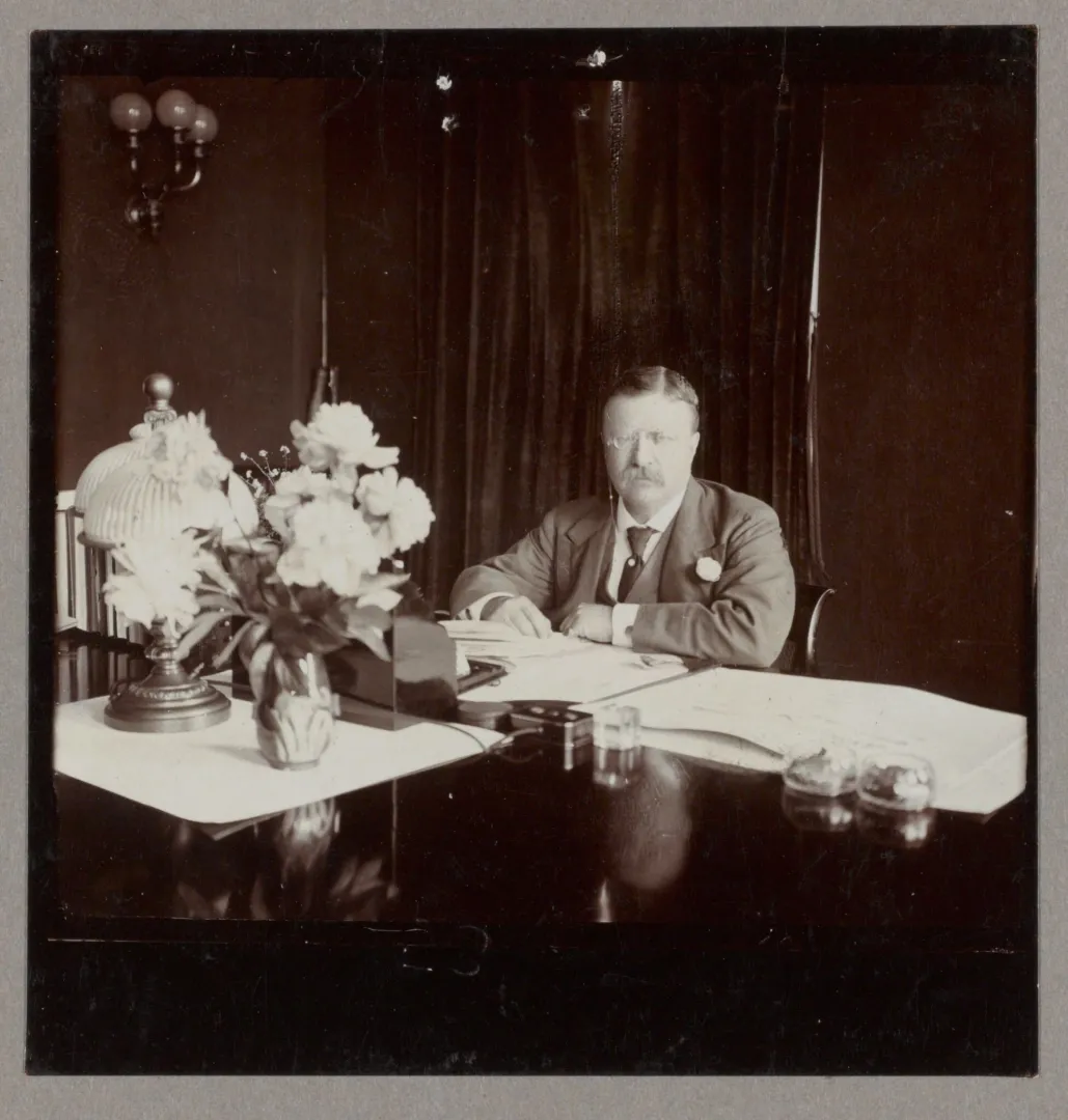 President Theodore Roosevelt seated at his White House desk