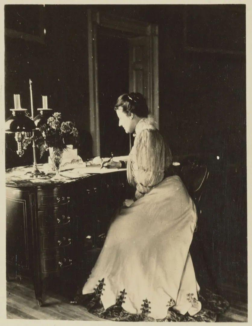 Edith Roosevelt seated at a writing desk at the White House