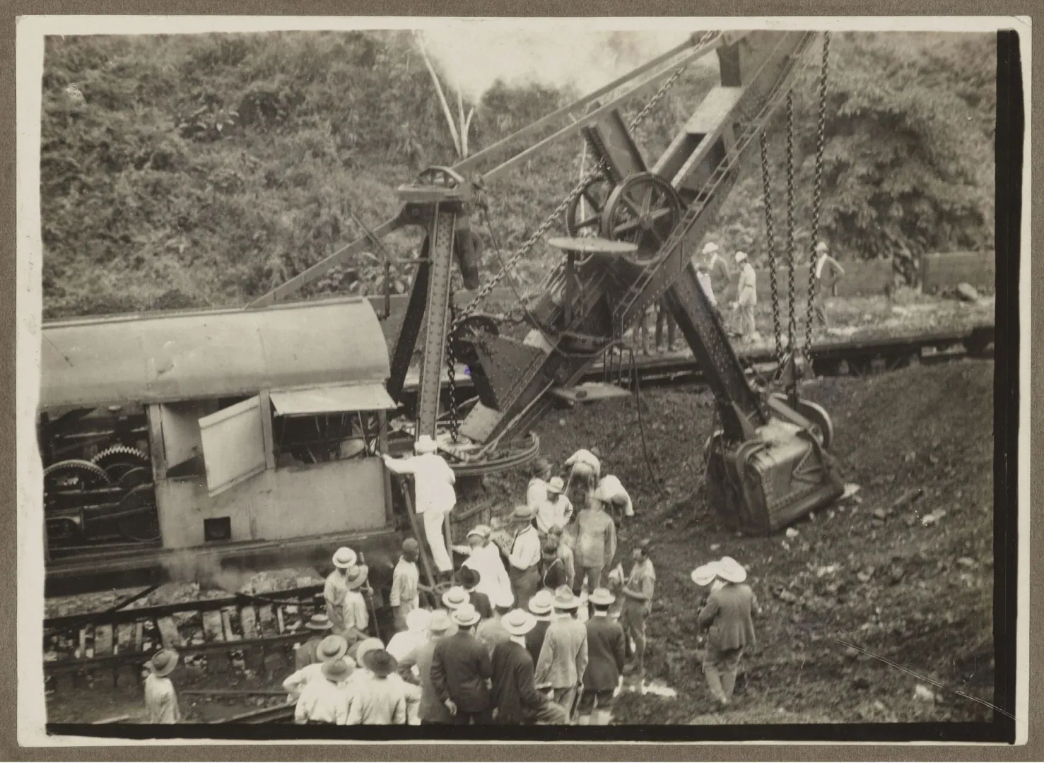 Theodore Roosevelt seated at the controls of a large steam shovel at the Panama Canal