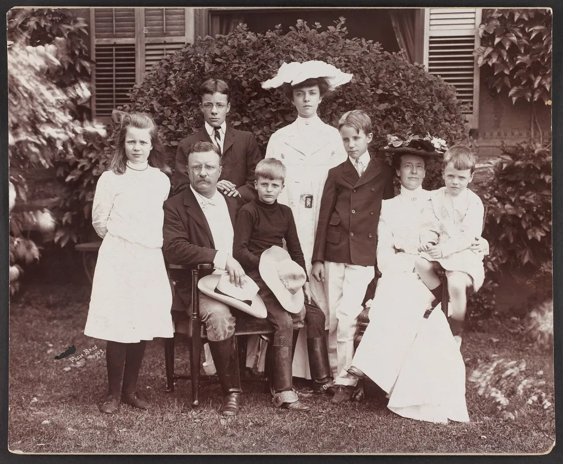 President Theodore Roosevelt seated on a lawn with his wife Edith and their six children, 1903.