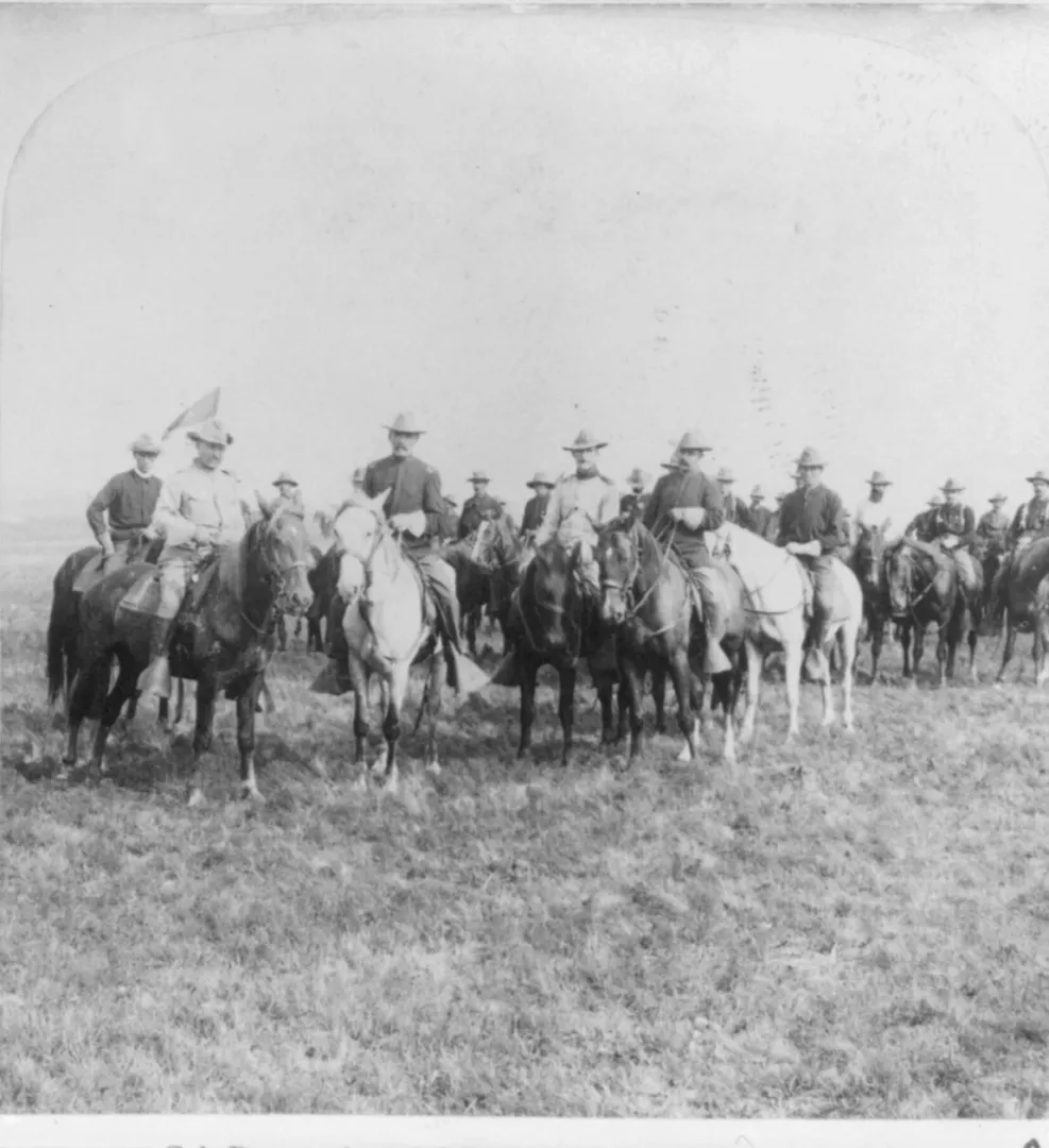 Colonel Theodore Roosevelt and mounted Rough Riders officers on the open prairie, 1898