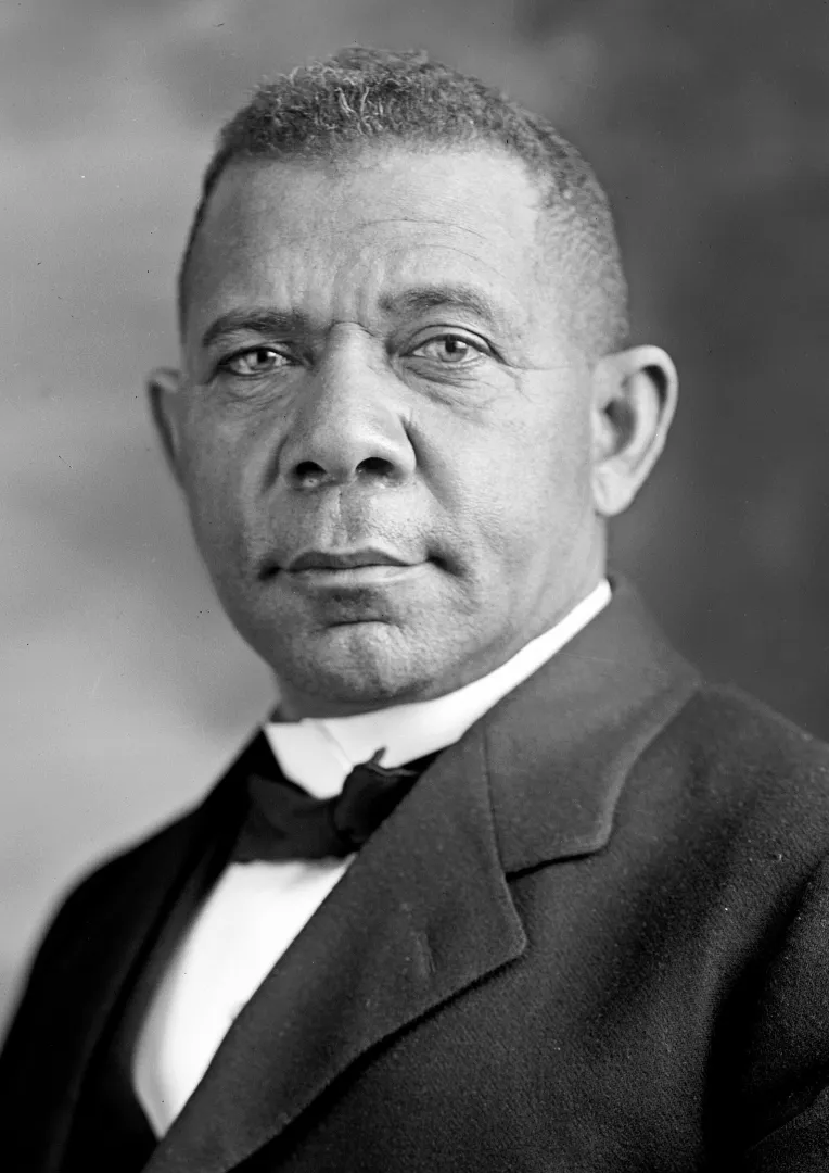 Formal studio portrait of Booker T. Washington wearing a dark suit and bow tie.