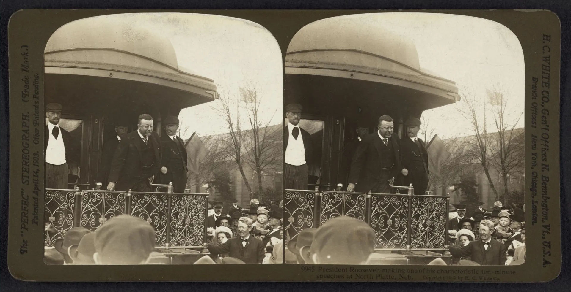Theodore Roosevelt gesturing while speaking from a flag-draped platform