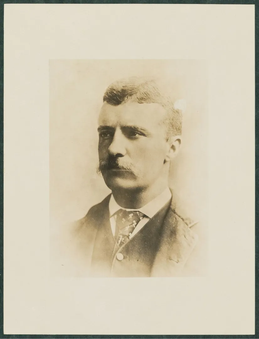 Studio portrait of a young, clean-shaven-cheeked Theodore Roosevelt with a mustache, facing the camera