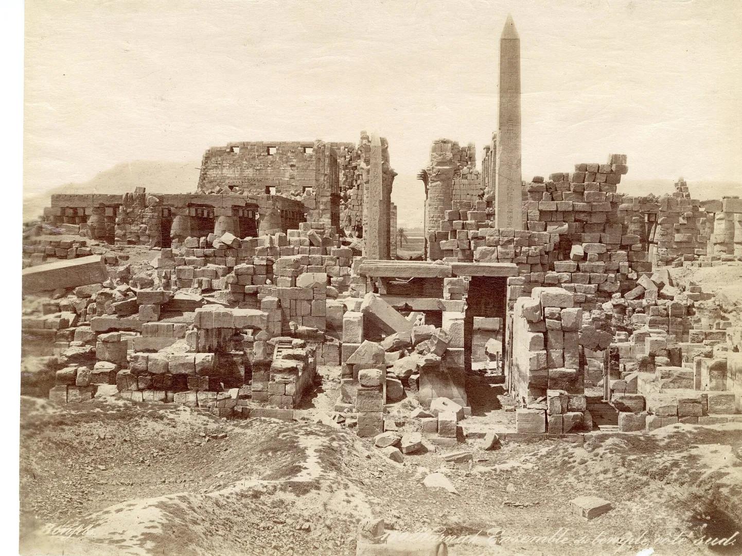 Nineteenth-century photograph of the ruined temple of Amun at Karnak, with a standing obelisk