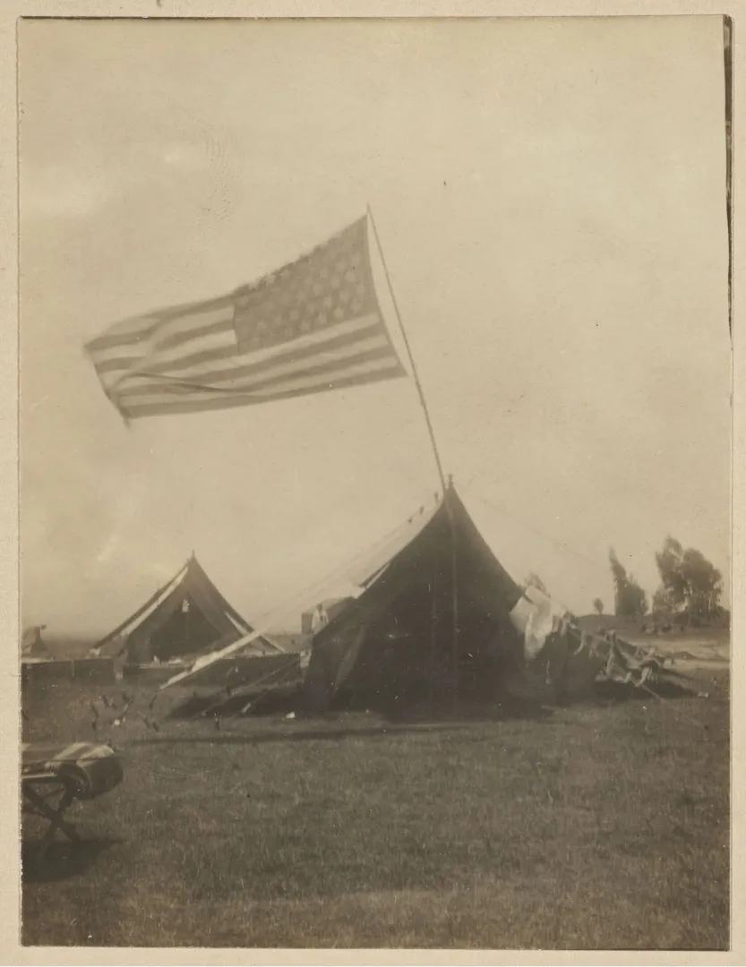 The expedition's tented camp beneath the American flag