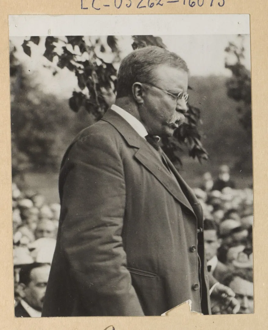 Theodore Roosevelt in profile addressing a crowd