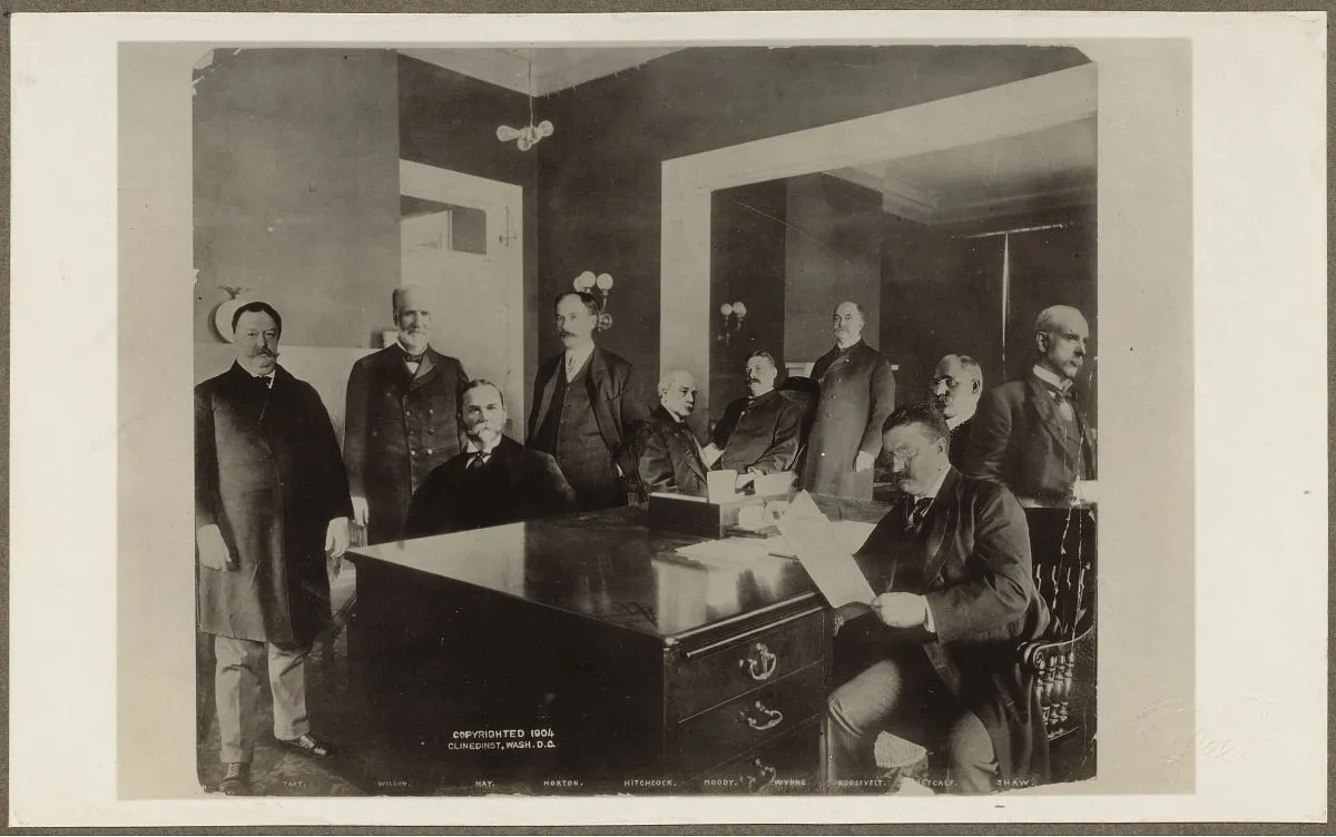 President Theodore Roosevelt seated with members of his cabinet around a table
